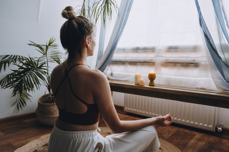 young woman doing yoga with candles Time For Yourself