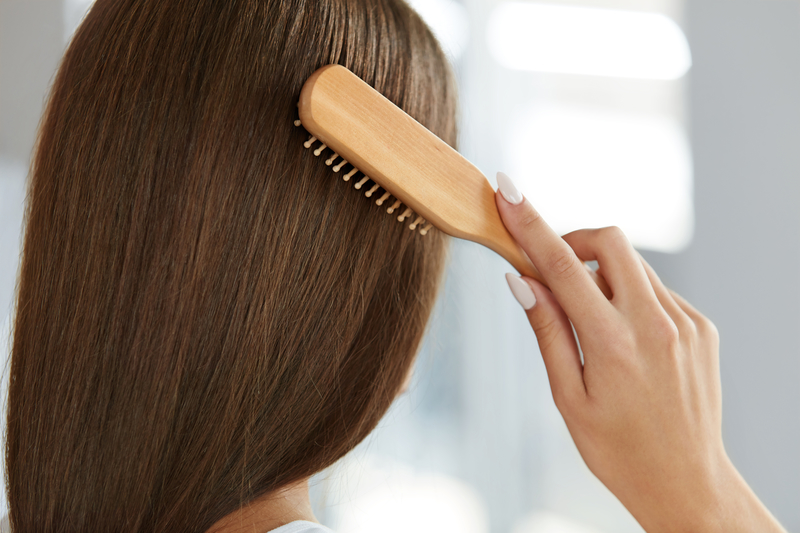 Back View Of Woman With Healthy Long Hair Brushing It With Brush How to Feel Confident About Your Hair