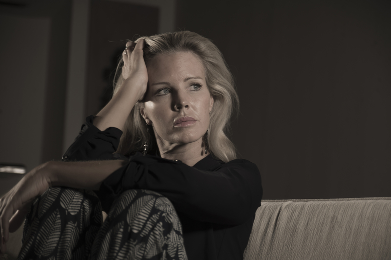 depressed and anxious beautiful blonde woman suffering depression and pain feeling frustrated sitting at home sofa couch sad and desperate in middle age crisis How to Feel Less Self-Conscious About Your Body